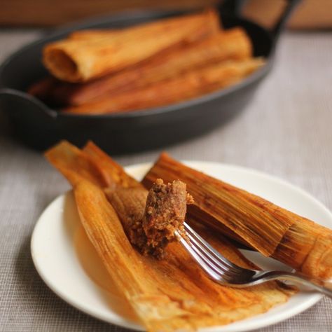 New Orleans-Style Hot Tamales | Emerils.com -- A spicy, chile-laden filling is rolled in corn husks and then steamed in a flavorful broth. These tamales do take some time, but invite friends over and make it a communal effort or do it in stages, time permitting. The filling can be made one day, then refrigerated for up to several days before rolling and steaming the tamales. Once cooked, the tamales hold well in the refrigerator up to several days, can also be frozen and microwaved to reheat. Hot Tamales Recipe Southern, Relleno Recipes, Hot Tamales Recipe, Cajun Meals, Food Recipes Mexican, Stuff Peppers, Mexican Tamales, Latin Dishes, Louisiana Cooking