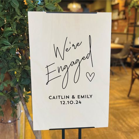 A gorgeous personalised wooden welcome sign for an engagement party decoration. This personalised wooden engagement party sign with the words "We're Engaged" printed onto the natural wooden sign make this a great personalised engagement sign for a couple who have just got engaged and wnat to celebrate their engagement with all their friends and family at their engagement party. The personalised engagement sign also makes a lovely sign for welcoming home a newly engaged couple who got engaged abr Engagement Parties Decorations, Diy Engagement Sign, Surprise Engagement Party Decorations, March Engagement Party, Engagement Party Photo Wall, Engament Party Decorations, Engagement Party Signs Welcome, Engagement Signs Ideas, Engagement Drinks