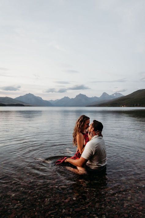 Outdoor Engagement Photos in Lake McDonald | Adventure Engagements | Montana Photographer. Lose yourselves in the beauty of Glacier National Park this summer and capture your love in a romantic lakeside engagement photoshoot. Find western engagement announcement, glacier national park engagement, lake engagement ideas and montana engagement photos. Book Brogan for your outdoor western engagement session at photographybybrogan.com. Lake Pictures Family, Glacier Engagement Photos, Engagement Lake Photoshoot, Engagement Announcement Photos Ideas, River Photoshoot Ideas Couple Photos, Lake Couples Photos, Family Photos In Water, Wedding Lake Photos, Engagement Photos In The Water