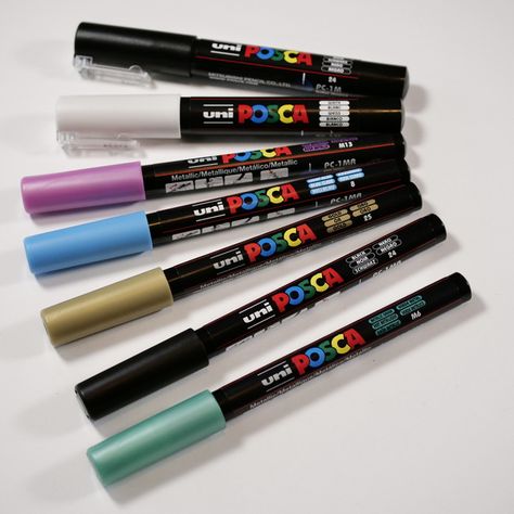 The Best Acrylic Paint Pens: A Paint Marker Comparison - Hop-A-Long Studio Best Acrylic Paint, Posca Paint Markers, Black Paper Background, Paper Backgrounds, Fine Point Pens, Tim Holtz Distress Ink, Acrylic Paint Pens, Brush Markers, Art Camp