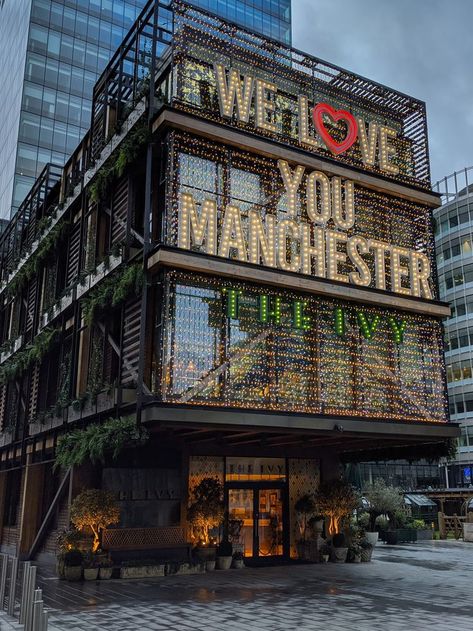 Modern building at twilight with illuminated text We Love You Manchester and The Ivy Maastricht, Manchester City Centre Aesthetic, Manchester Photography Locations, Living In Manchester, Manchester England Aesthetic, Manchester Uk Aesthetic, Manchester City Aesthetic, Manchester Flat, Manchester Trip
