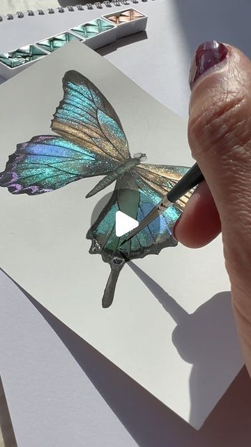 Metallic&shiny watercolor artist on Instagram: "✨Beauty of butterflies 🦋 ✨Wishing you a great weekend y’all 💆🏻‍♀️✨ . Using ghost pearls & sapphire shifters from @skrim_watercolors . 100% cotton hot pressed paper @fabriano1264 . . . . . #butterfly #beauty #butterflylove #butterflys #butterflytattoo #butterflyart #watercolortattoo #artlover #watercolortutorial #watercolortattoo #butterfly #butterflydrawing #watercolorart #art #aquarelle #drawing #illustration #illustrationartists #zarinartist" Metallic Watercolor Butterfly, Pearlescent Watercolor Paintings, Glitter Watercolor Painting, Shiny Watercolor, Glitter Art Painting, Metallic Watercolor Painting, Sparkle Painting, Finetec Watercolor, Watercolour Butterflies