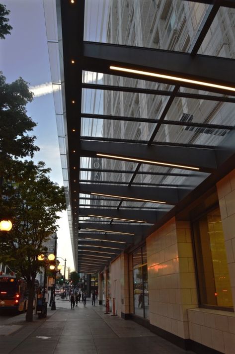 Storefront lighting for marquis retail establishment – KlikUSA Ulm, Awning Storefront Design, Glass Canopy Design Entrance, Storefront Canopy, Facade Lighting Architecture, Glass Canopy Design, Building Awning, Entrance Canopy Architecture, Commercial Awning