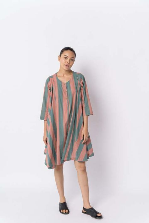 This candy-striped flared dress adds a touch of romance to your summer wardrobe. rendered in a voluminous silhouette with softly gathered shoulders this dress is lightweight and airy. carefully crafted from handwoven muslin made by the artisans of india. a resort evening a girl's day out or a brunch date this dress is a match for many special events.    - round neckline.  - front button placket.  - quarter sleeves.  - coconut buttons.  - falls 36" from the high point of the shoulder (based on size s)  - lined.  - voluminous flare.  - 100% handwoven cotton.  - soft Handwoven Fabric, Striped Short, Candy Stripes, Girl Day, Shirt Skirt, Flared Skirt, Pink Stripes, Striped Shorts, Fitted Bodice