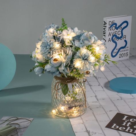 PRICES MAY VARY. PACKAGE - Including LED lights, 3 aritficial Blue Rose Bouquets and a Glass Vase. Total height is about 13”/33CM. Vase height is 6.3"/16CM. Flower height is about 13”/33CM. CREATIVE LED DECORATION - This Table LED flowers is perfect for your wedding, party, baby shower or home decor, etc. EASY TO SET UP- Put half of the led lights in the vase, and wrap the rest around the fake flowers. The LED lights have 8 remote control mode. LIGHT UP YOUR LIFE - The entire flowers and vase ar Artificial Flower Arrangements Centerpieces, Centerpieces Quinceanera, Blue Rose Bouquet, Blue Wedding Centerpieces, Blue Party Decorations, Centerpiece Home, Blue Centerpieces, Lighted Centerpieces, Blue Bridal Shower