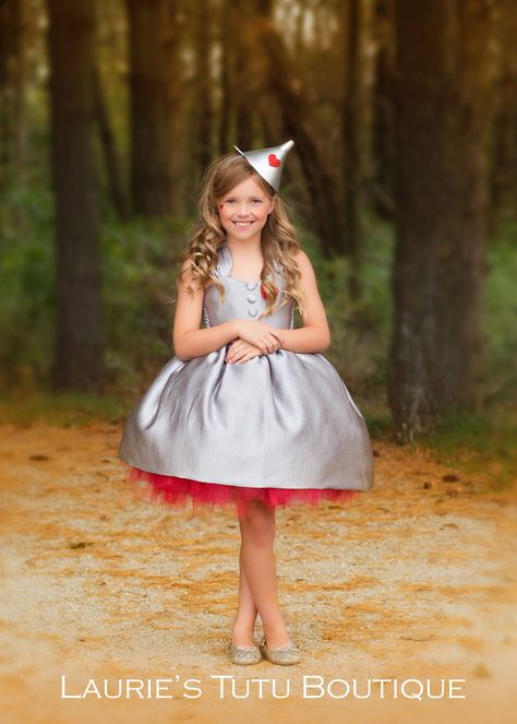 This Tin Man costume will steal your heart! The cutest little silver dress over a red tutu. It's made complete with silver buttons, a red heart and the perfect funnel hat/headband.  I like to have the following measurements when making your dress: 1. Chest Measurement 2. Waist Measurement 3. Length Measurement (from armpit down to desired length) Need a Dorothy costume, you can find it here: https://www.etsy.com/listing/594989189/wizard-of-oz-dorothy-dress Looking for the scarecrow costume, you Dorthy Costume, Wizard Of Oz Costumes Diy, Tin Man Costume, Scarecrow Dress, Fathers Daughter, Sofia Costume, Wizard Of Oz Tin Man, Tin Man Costumes, Duo Costume