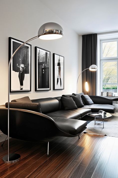 Revel in the simplicity of this minimalist living room with a sleek, black Italian designer sofa and monochromatic artwork, lit by a statement-making floor lamp. Minimal Living Room Lamp, Black Leather Couch Apartment, Leather Sofa Room, Black Couch Luxury Living Room, Black And Chrome Living Room, Leather Black Sofa Living Room Decor, How To Style Black Leather Couch, Sofa Black Living Room, Leather Couch Living Room Black
