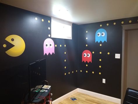 Video Game Room. I painted the black wall with Behr Marquee paint. I'm a little old school, so I added pac man for a little fun and color. www.allisrealtors.com Game Room Feature Wall Ideas, Video Game Room Paint Ideas, Old School Game Room, Video Game Room Decor Diy, Black Wall Game Room, Video Game Wall Mural, Game Room Wall Paint Ideas, Gaming Room Wall Paint, Kids Video Game Room