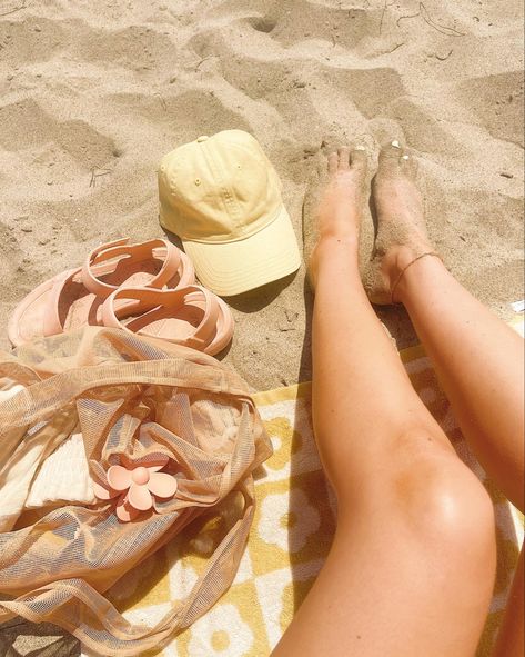 Photo of legs on a beach towel in the sand with a bag, hat and sandals Pastel, Yellow Beach Aesthetic, 70s Beach Aesthetic, Sandy Beach Aesthetic, Beach Babe Aesthetic, 60s Beach Aesthetic, Sandy Aesthetic, 1989 Tv, Main Squeeze