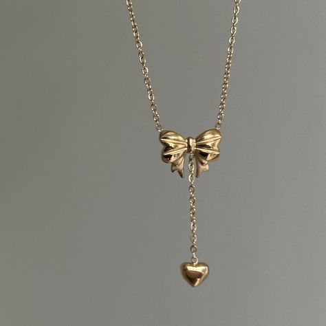 "Bow Drop Heart Necklace  ✨ Fully stainless steel & tarnish proof! (18k gold plated) 15.5\" with a 2\" extender  oval link chain style featuring a unique mini gold puffed bow pendant & mini heart pendant 🤍 Handmade with love!" Gold Necklace With Heart Pendant, Chain Heart Necklace, Cute Heart Necklace, Gold Bow Jewelry, Gold Coquette Jewelry, Cool Gold Jewelry, Dream Jewelry Necklaces, Gold Bow Necklace, Golden Necklace Design