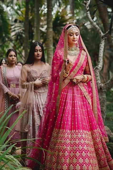 All you beautiful Brides to-be!! Tired of seeing the same old red lehenga ? Want to try something Different yet Traditional? Check out these Magenta Bridal Lehenga that would make you look exceptionally pretty at your Wedding. #indianwedding #shaadisaga #intimatewedding #lehenga #bridallehenga #weddingoutfits #indianweddingtrends #magentalehenga #indianbridal #bridalfashion #indianweddinginspiration Reception Ghagra Bridal Lehenga, Lahga Design Bridal Lehenga, Magenta Lehenga Bridal, Magenta Wedding Lehenga, Pink And Red Lehenga Bridal, Coral Lehenga Bridal, Wedding Ghagra Brides, Wedding Lehengas Bridal Pink, Pink Bridal Lehenga Brides