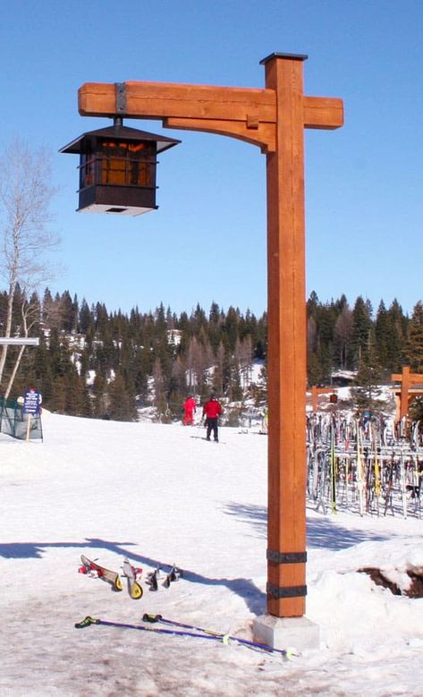 Custom wood built light post at a ski resort with a gas lantern hanging from it. Skis and snow surrounding it.  Caribou Creek Log Homes builds more than just houses. We build specialty item such as staircases, entry ways, sign posts, and custom furniture. #Cariboucreekloghomes #handcraftedlogstructures #handcraftedstaircase Outdoor Lamp Posts, Rustic Light Post Outdoor, Diy Lamp Post Outdoor, Garden Lamp Post, Driveway Lighting, Lantern Hanging, Light Post, Lantern Post, Sign Post