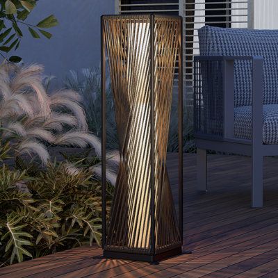 Outdoor Solar-Powered Resin Wicker Floor LampPerfect Outdoor Solar Light For YouEvery patio needs its finishing touches. Durable yet beautiful, our patio floor lamps are the perfect finishing touch to an outdoor oasis. | Grand Patio 30" Solar Powered Integrated LED Outdoor Floor Lamp in Brown | 30 H x 7.9 W x 7.9 D in | Wayfair Floor Lanterns, Solar Garden Decor, Sustainable Lighting, Porch Inspiration, Patio Floor, Outdoor Floor Lamp, Solar Lanterns Outdoor, Lamp Brown, Zen Garden Design