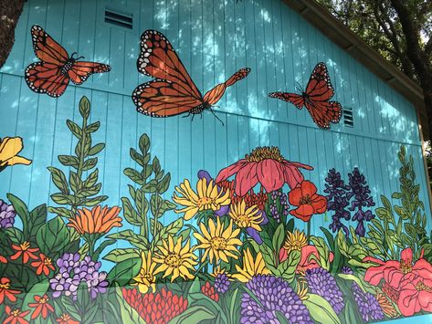 Flower And Butterfly Mural, Mural On Side Of Shed, Garden Mural Outdoor Wall Art Diy, Elementary School Murals Outside, Outdoor Mural Ideas Flower, Big Flower Mural, Garden Mural Outdoor Wall Art Paint, Spray Paint Mural Wall Art, Painted Garage Door Mural