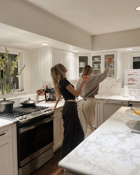 Two people toast in a warm, inviting kitchen, embodying the spirit of home entertainment and togetherness for the upcoming year. Dancing In The Kitchen, Post Grad Life, Post Grad, Female Friendship, Apartment Aesthetic, Future Apartment, Future Lifestyle, Dream Apartment, Nyc Apartment