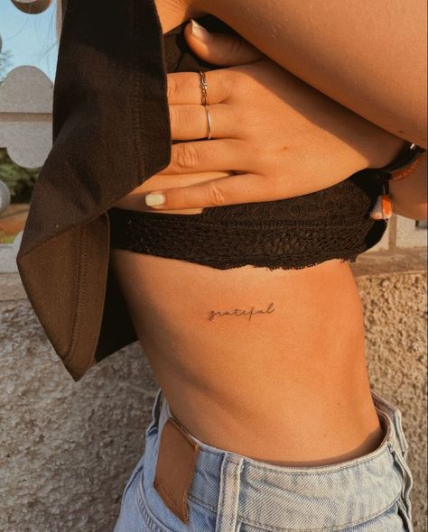 Pinterest Women Ribs Tattoo Ideas, Aesthetic Tattoo Ideas Women, Womens Elegant Tattoo, Written Tattoo Ideas Female, Mostest Tattoo, Best Place On Body For Tattoo, Tattoo Ideas Grateful, Back Rib Tattoo Women, Dainty Ribcage Tattoos For Women