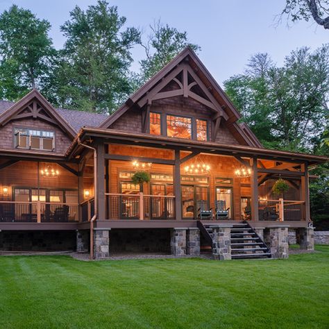 A deep wrap-around porch resting on stone pillars dominates the lakeside of this home overlooking a pristine Adirondack lake. Dream House With Wrap Around Porch, Log House With Wrap Around Porch, Big House With Wrap Around Porch, Log Cabin Home With Wrap Around Porch, Log Cabins With Wrap Around Porch, Mountain House Wrap Around Porch, Stone House With Wrap Around Porch, Cabins With Wrap Around Porches, Rustic Wrap Around Porch