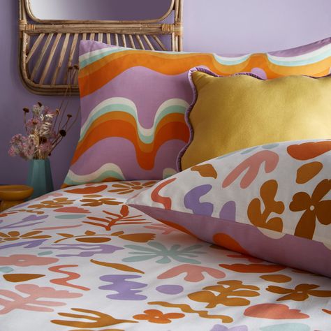 Fun, funky and retro-inspired, the cheerful Amelie duvet cover set features bright, abstract florals in boldly colored geometric shapes, printed on a fresh white background. This uplifting and retro story celebrates unique styling and the freedom to express yourself. On the reverse, wavy lines and icons get a cheeky twist with bold and high-contrast looks, outlined by the rich mauve tone. Ideal for those who love to add a splash of fun and color to their bedroom. Size: 137cm W x 200cm L Duvet Covers Dunelm, Funky Bedding, Funky Room Decor, Retro Bedding, Accent Chair Bedroom, Modern Duvet, Corner Sofa Chaise, Colorful Duvet Covers, Retro Bed
