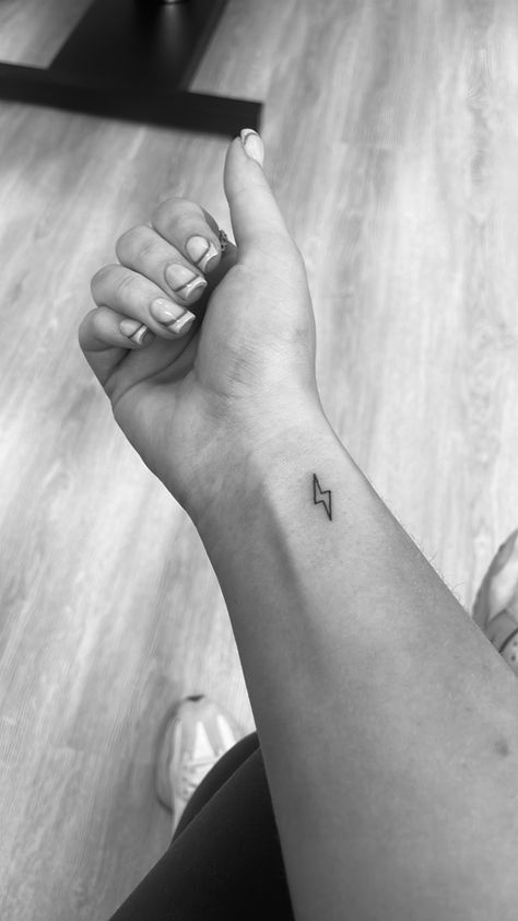 Lightning Bolt Outline Tattoo, Lightning Outline Tattoo, Behind The Ear Lightning Bolt Tattoo, Small Tattoos Lightning Bolt, Lightening Bolt Tattoo Women, Lightning Bolt Wrist Tattoo, Simple Lightning Bolt Tattoo, Tattoo Ideas Lightning Bolt, Lighting Bolt Tattoo Meaning