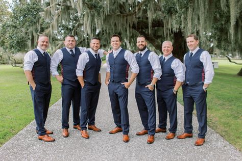 Groom and groomsmen pose for pictures before charming southern wedding. Love their cognac shoes and blue pants and vests! Check out the rest of the wedding at thebridalfinery.com. Blue and tan menswear // mens wedding fashion // groomsmen ideas // groomsmen outfits Groomsmen Just Vests, Mens Dress Shirts For Wedding Groom And Groomsmen, Gray Vest And Pants Groomsmen, Groomsmen Just Shirt And Tie, No Jacket Wedding Groom Attire, Black Groom Navy Groomsmen, Navy Blue Beach Wedding Groomsmen, Groom Outfit No Jacket, Vest Only Groomsmen