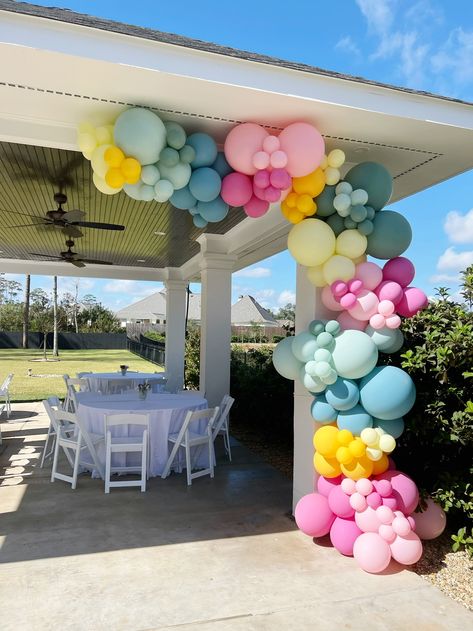 Spring Colors Balloon Garland, Floor Balloon Garland, Balloon Garland On Pergola, Outdoor Balloon Garland Ideas, Balloons On Pergola, Balcony Balloon Garland, Poolside Balloon Decor, Storefront Balloon Garland, Muted Color Balloon Arch