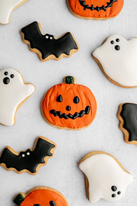 These Halloween sugar cookies are the perfect way to ring in the spooky season! They're so easy to make, and the entire family will have fun decorating them. #halloween #halloweencookies Crumbl Halloween Cookies, Halloween Baking Ideas Cookies, Easy Decorated Halloween Cookies, Halloween Cutout Cookies, Mini Halloween Cookies, Halloween Iced Cookies, Halloween Cookies Pumpkin, Halloween Cookies Ideas, Decorating Halloween Cookies