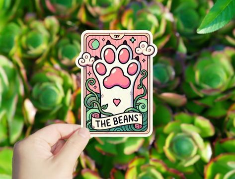 1 pack Paw Beans Vinyl sticker , sticker for tablets laptop Wall Car Windows Bumper Water Bottle Tumple Truck Van Decoration Graphics This sticker features an illustration of a cat's paw, often affectionately referred to as "beans" due to the appearance of the pads on the paw. The paw is set against a whimsical, fantasy-like background with vines, clouds, and a heart, giving it a playful and magical feel. The text "THE BEANS" at the bottom emphasizes the focus on the cute, round pads of the paw, which are beloved by cat enthusiasts. The sticker likely symbolizes affection for cats, the cuteness of their paws, and perhaps a sense of comfort or softness associated with them. Size: 1 Inches X 1 Inches, 2 Inches X 2 inches, 3 Inches X 3 Inches, 4 Inches X 4 Inches Every sticker is printed on d Van Decoration, Cat's Paw, Tablet Laptop, Car Window, Car Windows, Vinyl Sticker, Water Bottle, Tablet, Laptop