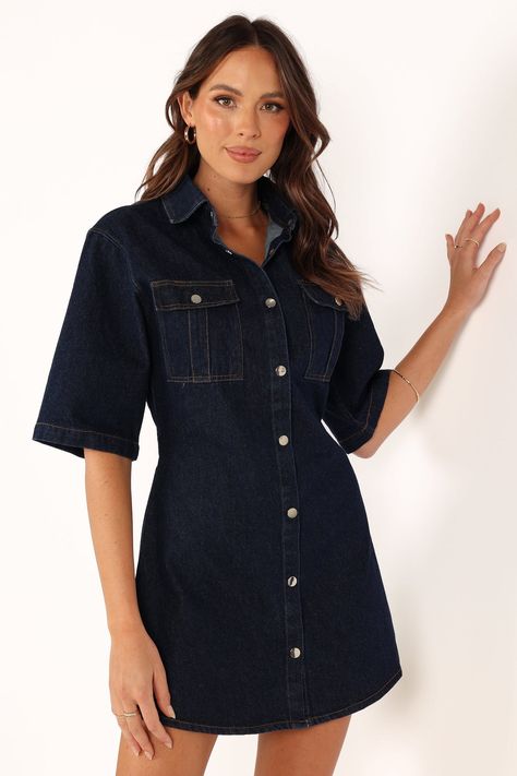 DETAILS  Are you ready to beat the summer heat in style? Look no further than our denim mini dress. Featuring a spread collar, short sleeves and functional buttons down the front, this dress is perfect for everyday wear. When purchasing this item, we recommend sizing up. This will ensure maximum comfort and a perfect fit.   denim mini dress spread collar short sleeves  functional buttons down front functional chest pockets back elasticised waist band unlined  material - 100% cotton          SIZI