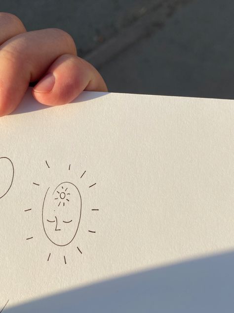 photo of minimalist little sketch on the sketshbook on the street at the sun. flash is about small dumpy face with cute sun inside the head and sunshine lights from the face Sun Doodle Tattoo, Sun Line Art Tattoo, My Only Sunshine Tattoo, Light Tattoo Ideas, Light Tattoos, Sun People, Sun Doodles, Sun Tattoo Small, Sunshine Tattoo