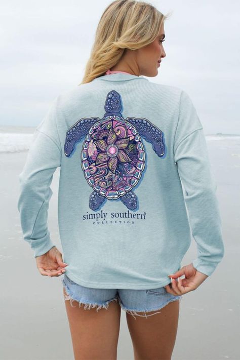 Stay cozy in this Simply Southern Tracking Turtle Boxy Crewneck Pullover for Women in Blue. Perfect for any outdoor adventure, this pullover will keep you warm with its long sleeves, midweight material and ribbed cuffs. Features: Simply Southern Style: TRACK-BOXY-PULL-MDL-OCEAN Color: Teal Heather Women’s pullover Long sleeves Ribbed neck and cuffs Back graphic: multi colored turtle graphic Simply Southern logo tag on front Simply Southern logo on front and under back graphic Curved hems Measurements from a size small: Length from center back: 27” Chest: 43” Southern Logo, Turtle Graphic, Nora Fleming Minis, Jewelry By Brand, Picture Frame Ornaments, Brighton Handbags, Ocean Colors, Simply Southern, Oversized Silhouette