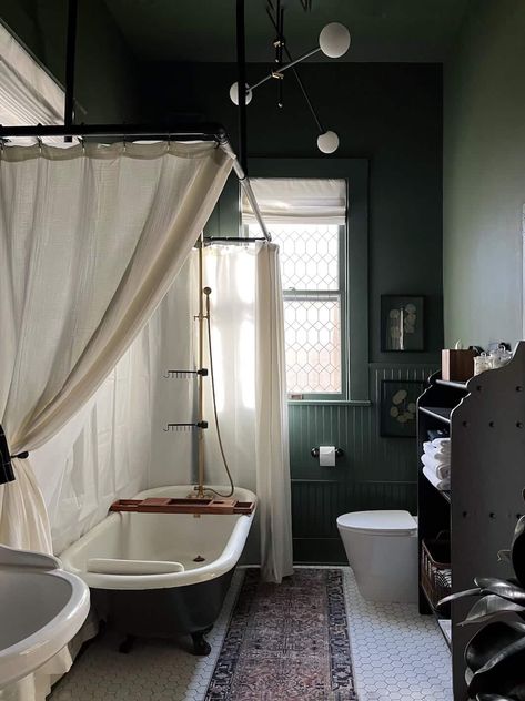 This bathroom was a labor of love, and I can’t believe how well it turned out. I took an awkwardly disproportionate space with a rusty tub, peeling wallpaper, and cracked tiles to the cozy dark green bathroom of my dreams. Here it is before: This post may include affiliate links, which means I may earn […] Dark Green Bathroom, Green Bathroom Paint, Green Interior Paint, Moody Bathroom, Dark Green Bathrooms, Clawfoot Tub Shower, Interior Paint Colors, Clawfoot Tub, Green Bathroom