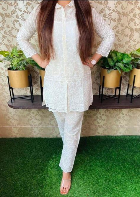 "Add a touch of sophistication to your wardrobe with this stunning White Shirt Kurti and Kurta set. Made with luxurious Cotton, it comes in different sizes and features 3-4th Sleeves and a Collared neck. The special work done on the fabric using Chikankari, Embroidery, Sequins technique adds an irresistible charm. Kurti is thigh length. Made in India, this set comes with a guarantee of superior quality fabric. Wear it to Formal, Casual, Festive, Family Celebrations, Parties, Social, Office, College, Outing occasions and make a statement. DETAILED DESCRIPTION Product : Aline Kurti Shirt Pant set Fabric : Cotton Primary Color : White Sleeves : 3-4th Sleeves Sizes available : M, L, XL, 2XL Kurta Length : Thigh length Work/Detailing : Chikankari, Embroidery, Sequins Occasion : Best for Formal, Smart Pants, White Kurta, Summer Tunics, Kurtis With Pants, Traditional Indian Outfits, Shirt Pant Set, Designer Kurtis, Embroidered Border, Tunic Style