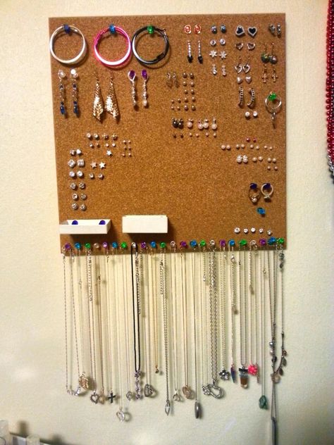 Cork boards are lifesavers for organizing jewelry. Just pin your earrings into the board and you can even pin little boxes to keep the backs in. I just used regular thumb tacks for dangly earrings, necklaces, and even some rings! Ways To Hang Jewelry, Organisation, Jewelry Cork Board, Cork Board Jewelry Organizer Diy, Jewelry Organizer Diy Wall Stud Earrings, Earring Corkboard, Earing Organization Ideas, Earrings Storage Ideas, Organizing Jewelry Ideas