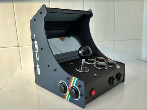 My ZX style retro arcade cabinet. Size is 240x210x200 so could be a strech on normal bed size printers. First I printed all the panels in PLA, but at the end decided to go for acrylic as it's cheap and looks better. The guts are: Raspberry Pi3 running Retropie Waveshare 7" LCD screen Cheap Chinese Arcade USB control (12 buttons+Joystick) USB speaker The STL file is just to show how it looks, I've included the 123d and step files so all the parts can be exported or altered for printing. Video Game Cabinet, Pi Arcade, Arcade Controller, Arcade Bartop, Diy Arcade Cabinet, Arcade Console, Retro Games Room, Arcade Room, Retro Bed