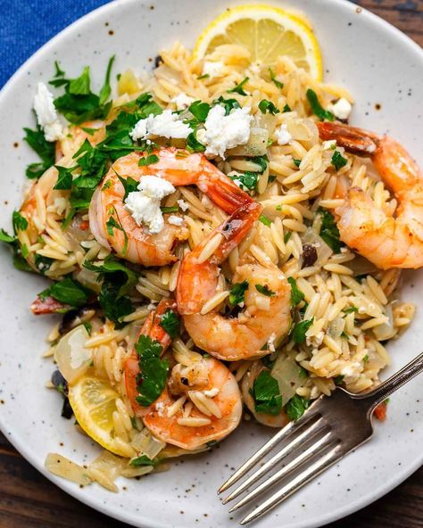 This orzo with shrimp is a delicious one-pot dish that's easy to make and ready in about 30 minutes. Orzo, feta, olives, and fresh lemon zest and juice are tossed with succulent shrimp and finished with fresh parsley. This is a weeknight go-to! #orzo #shrimpandorzo #mediterraneanrecipes Orzo With Shrimp And Feta, Orzo With Shrimp, Orzo Feta, Lemon Pepper Shrimp, Shrimp Orzo, Orzo Dishes, Sip And Feast, Lemon Shrimp, Orzo Recipes