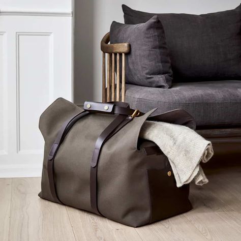 A green canvas weekender bag on the floor with a grey sweater laid on top of it.. This image was included in the article: The Ultimate Guide To Men’s Weekender Bags, on MensFlair.com Canvas Duffle Bag Men, Travel Accessories For Men, Canvas Weekender Bag, Leather Holdall, Canvas Duffle Bag, Weekender Bags, Holdall Bag, Canvas Leather Bag, Leather Weekender Bag