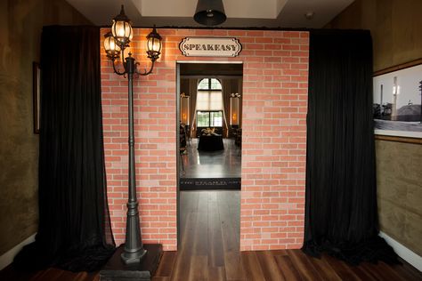 Custom made speakeasy secret entrance door for a Prohibition party theme with Roaring 20's Art Deco graphics and decor  by Unlimited Events  #gatsbyparty #greatgatsby #roaring20s #speakeasy #themeparty #speakeasydoor #customeventdecor #prohibition #prohibitionparty #roaring20stheme Speakeasy Door Entrance Diy, Prohibition Halloween Party, Bootleggers 1920s Speakeasy Party, Roaring 20s Party Entrance, 1920s Prohibition Party, Roaring 20s Halloween Party, Speakeasy Bar Entrance, Speak Easy Theme Party, Speak Easy Door Ideas