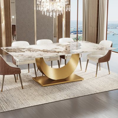 This glam-inspired round dining table brings a touch of elegance to your dining space. The faux marble top offers a sophisticated look, while the stainless steel pedestal base adds a modern flair. With a weight capacity of 100 lbs. this table is ideal for hosting intimate dinner parties or family meals. The pedestal base design allows for ample legroom and easy seating arrangement, ensuring a comfortable dining experience. Enjoy the perfect blend of style and functionality with this stunning din Modern Dining Table Gold, 2 Chandeliers Over Dining Table, Beige Dinner Table, Marble Dining Table Design Modern, Modern Formal Dining Room, Modern Dining Room Table Decor, Triangle Dining Table, Modern Luxury Dining Room, Marble Kitchen Table