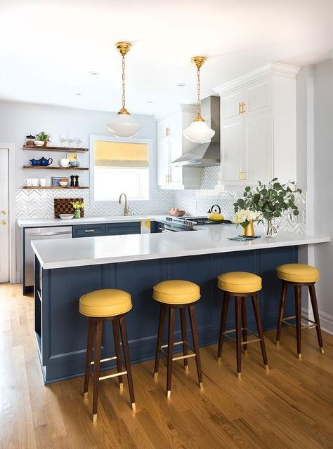 Four yellow backless barstools sit at a blue kitchen peninsula fitted with shelves and topped with a white quartz countertop illuminated by white glass vintage schoolhouse pendants. Blue Kitchen Designs, Two Tone Kitchen Cabinets, Bistro Kitchen, Kitchen Peninsula, Pretty Kitchen, Custom Kitchens, Yellow Kitchen, Style Deco, Classic Kitchens