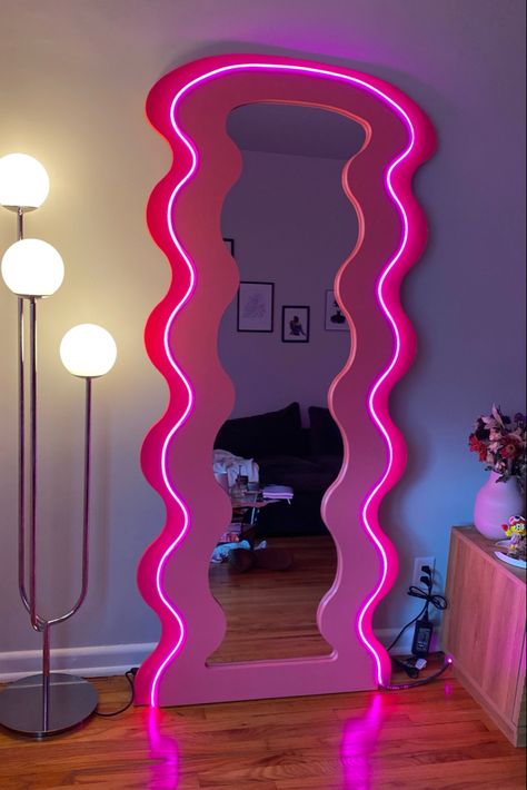 LED mirror. Blob mirror. Tall curvy mirror. Pink home decor Squiggly Mirror Aesthetic, Swiggle Mirror, Cute Mirrors For Room, Curvy Glow Mirror, Maximalist Makeup Room, Funky Lamps Bedroom, Fun Mirror Ideas, Funky Room Decor Bedroom, Wacky Mirror
