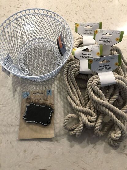 I think I have become addicted to Dollar Tree DIY’s. I was in my local Dollar Tree store recently and found some nautical rope. It’s nice quality, so naturally I grabbed 5 of them! Then I was like, hmmmm……ok, what the heck am I going to do with this. As I continued walking around the store, I found some small wire baskets, and some mini chalkboard signs, and the idea to try my hand at making a DIY Dollar Tree Rope Basket came into my head. Here is how I did it…   Here are the supplies… Upcycling, Rope Storage Basket Diy, Diy Camper Decor Dollar Stores, Camper Signs Diy Ideas, Diy Kitchen Utensil Holder, Mini Chalkboard Signs, Diy Declutter, Dollar Tree Baskets, Tree Rope