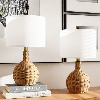 This 2-piece pair of table lamps gives your home a beachy vibe with their airy, open design. Each lamp sits on a sturdy base with a handwoven rattan body with a golden hue that leans into the rustic, coastal feel we love. Up top, the white linen drum shade adds modern flair that's just right for providing warm lighting and natural ambiance to your living room or bedroom. Inside the shade, each lamp houses a single 60W bulb (sold separately), and is easy to operate with the rotary socket switch. Beach Lamps Coastal Style, Wicker Lamps, Rattan Lamps, Beach Lamps, Rattan Table Lamp, Coastal Lamp, Mid Century Modern Table Lamps, Warm Lighting, Rustic Coastal