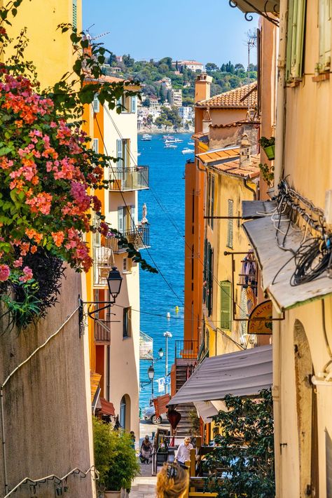 Narrow streets and historic houses of old town with Rue de lEglise street in Villefranche-sur-Mer resort town in France Antibes France Old Town, France Streets, Old City Street, Nice Old Town, France Street, City Streets Photography, Antibes France, Villefranche Sur Mer, French Summer