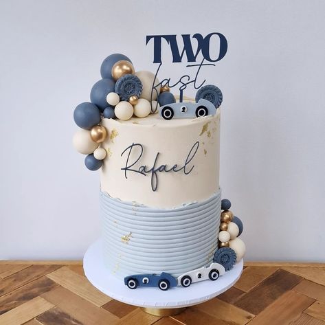 Car and race-inspired tall birthday cake 2nd Birthday Cakes For Boys, Birthday Cake For Boys 2nd, Vintage Race Car Birthday Cake, Race Car Birthday Cake Ideas, Birthday Cake Car Theme, Race Car Cakes For Boys, Two Fast Cake Birthday, Fast One Birthday Cake, Race Car Cupcakes