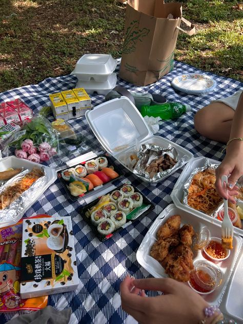 On a blue picnic blanket depicts an array of Asian food ranging from beverages and hot foods. Many hands reach for the food as they are about to eat. Picnic Asian Food, Friend Potluck Aesthetic, Picnic At Home Ideas, Asian Picnic Food, Picnic Food Ideas Healthy, Sushi Picnic Aesthetic, Asian Picnic, Food Date Ideas, Date Ideas Friends