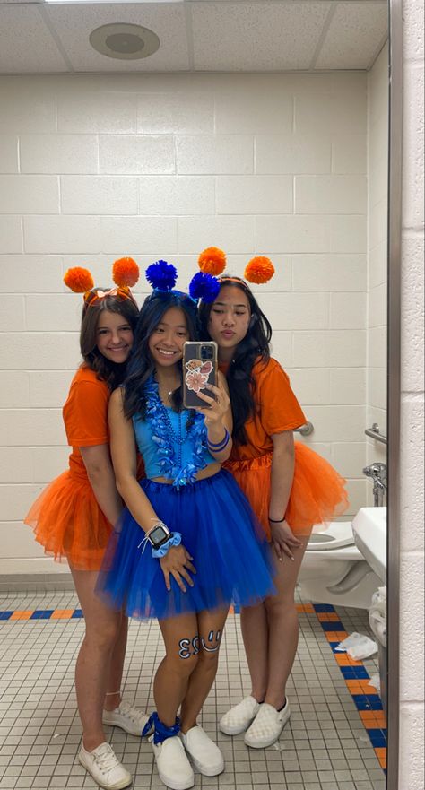 school spirit week, orange school spirit, blue school spirit, friday night lights football, color wars, color tutus, pom pom head bands, mirror picture #schoolspirit #blueout #orangeout #fridaynightlights #football #tutu Red Out School Spirit, Orange And Blue Football Outfit, Orange And Blue Spirit Day Ideas, Blue And Gold School Spirit Outfit, School Pride Outfit Ideas, Black Out School Spirit Outfits, Spirit Makeup Football, Class Color Day Spirit Week Outfits, Class Color Day Spirit Week Blue