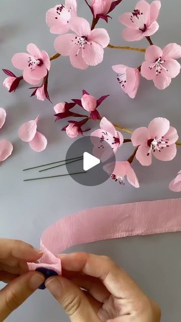 Aysel Bayrak on Instagram: "Sakura ❤️ 

Thanks 👉 Repost from @misspetalandbloom
•
Making cherry blossoms! I gotta say these little blooms look deceivingly simple but they’re a tough one to crack! Went through multiple multiple prototypes to get to this one and whoosh I’m glad to finally reach this point 😂🌸
.
#papercherryblossoms #papersakuras #crepepapersakuras #cherryblossoms #sakura #diysakura #paperflowers #crepepapercherryblossoms #crepepaperflowers" Sakura Flower Paper Craft, Paper Blossom Flowers, How To Make Blossom Flowers, How To Make Paper Cherry Blossom Flowers, Paper Sakura Flower, Diy Sakura Flower, Sakura Themed Party, Cherry Blossom Paper Flowers Diy, Diy Cherry Blossom Flowers