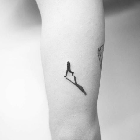 Black tattoo of a walking man’s silhouette Walk In Tattoos, 22 Tattoo, Wrist Tattoos For Guys, Silhouette Tattoos, Tattoos Geometric, Modern Tattoos, Small Tattoos For Guys, Tattoo Kits, Up Tattoos