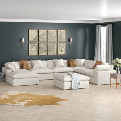 This U-shaped sectional seats up to five people, offering plenty of room for family and friends. It includes eight pieces: Three corner chairs, three armless chairs, and two ottomans. It features a modular and reversible design that can be easily recombined to suit your space. This sectional is crafted with a kiln-dried solid and engineered wood frame, and it rests on solid wood block feet with a brown finish. It's wrapped in stain-resistant fabric upholstery in an off-white hue, and its foam- a Sectional U Shaped, Living Room With Sectional, Brown Leather Ottoman, U Shaped Couch, Corner Chairs, Couch With Ottoman, Room Vibes, Large Sectional, Sectional With Ottoman