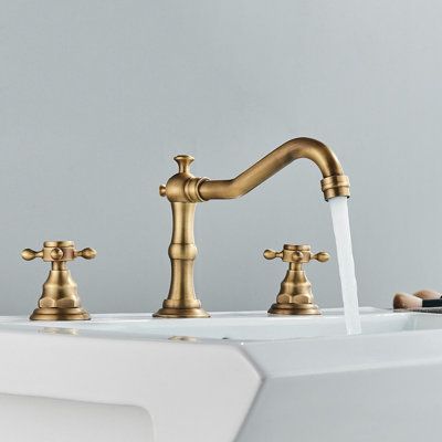 The bathroom faucet sink has 3 holes, and the 2 cross handles are respectively connected to the hot and cold water pipelines to precisely control the temperature and water flow. Antique brass bathroom faucets can save you a lot of time and effort in replacement and maintenance. | Augusts Widespread Bathroom Faucet in Yellow | 8 W in | Wayfair Aged Brass Bathroom Fixtures, Wide Bathroom Sink, Vintage Bathroom Faucet, Antique Brass Bathroom Faucet, Gold Bathroom Fixtures, Brass Bathroom Fixtures, Gold Bathroom Faucet, Bathroom Vanity Faucets, Vintage Faucet